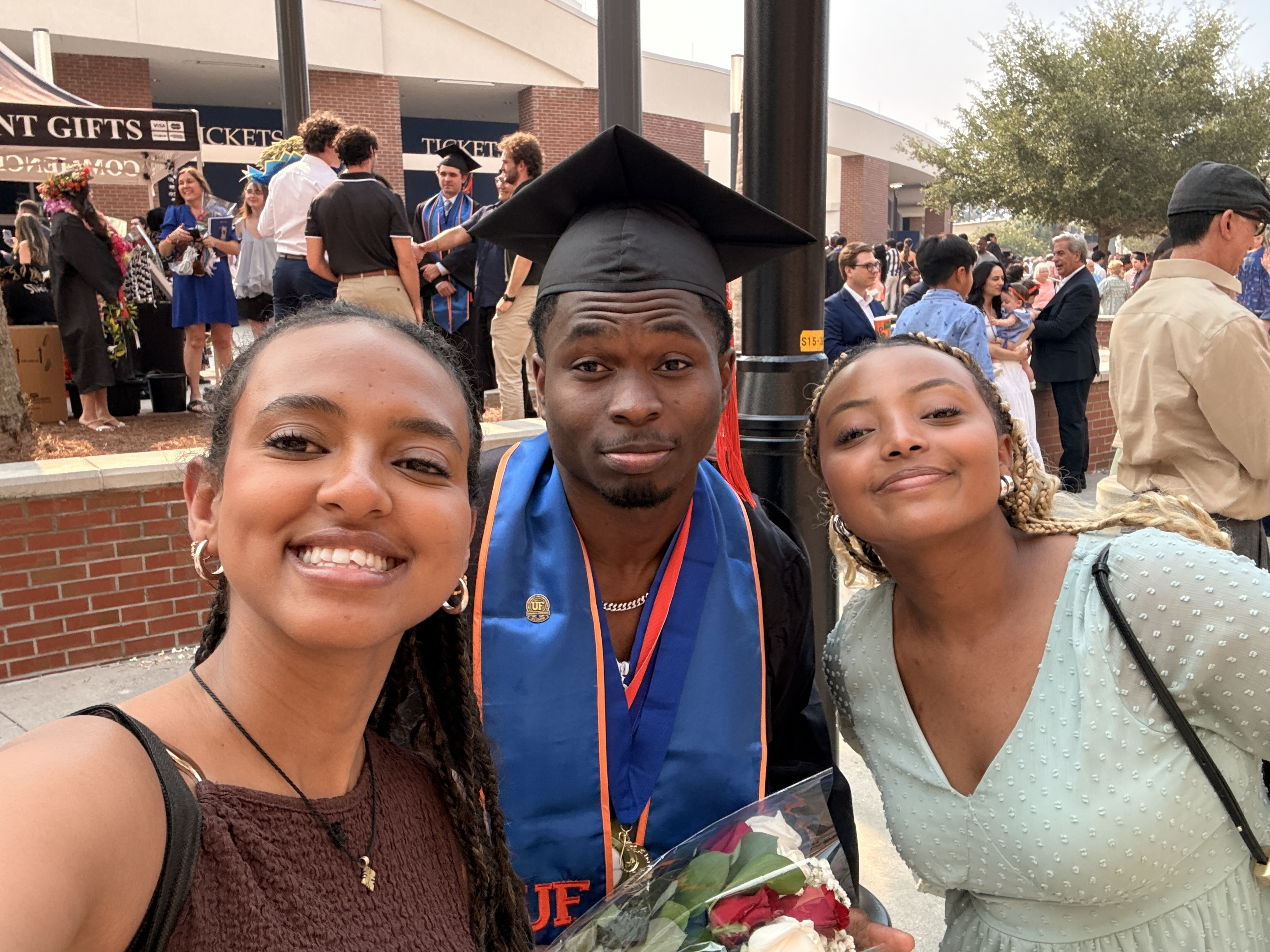 Melvin with friends at graduation